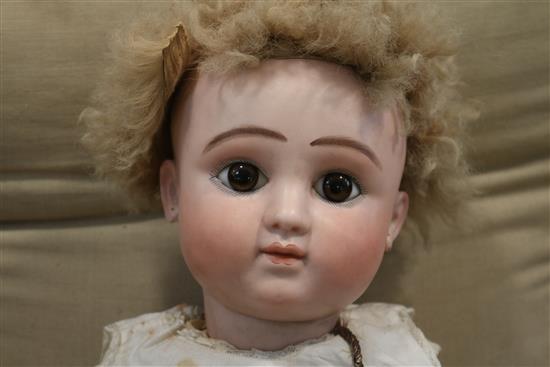 A late 19th century German bisque head doll 29in.
